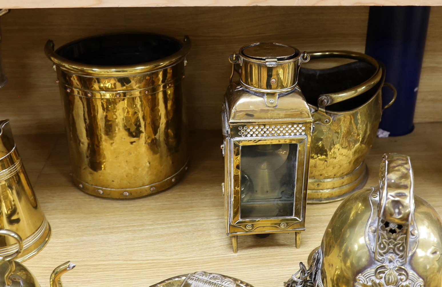 Sundry brass and copper, including a brass fireman’s helmet, a coal helmet, a staved and coopered wood and copper jug, a Victorian brass warming pan, a Victorian copper warming pan, a Victorian brass kettle etc.